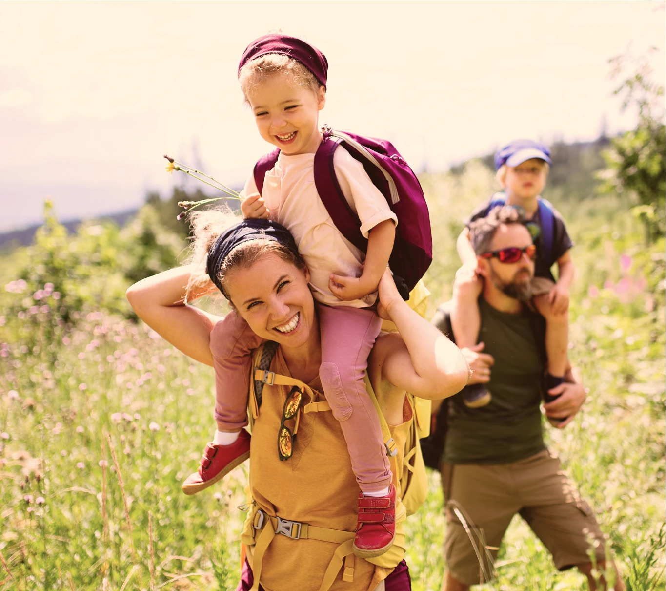 Man and women hiking with their children