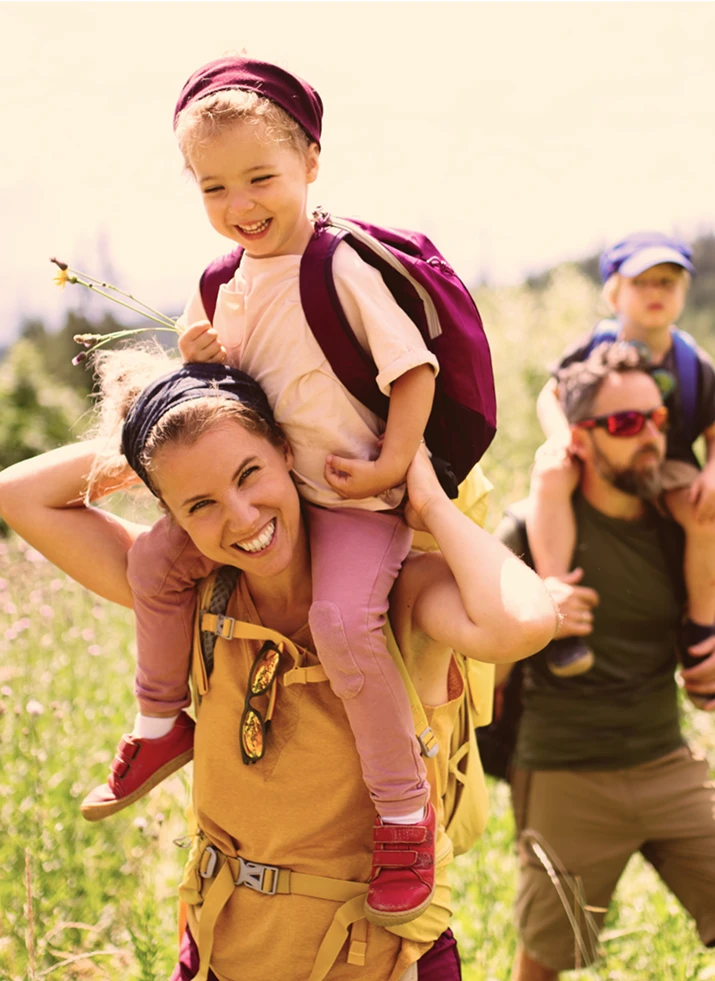 Man and women hiking with their children