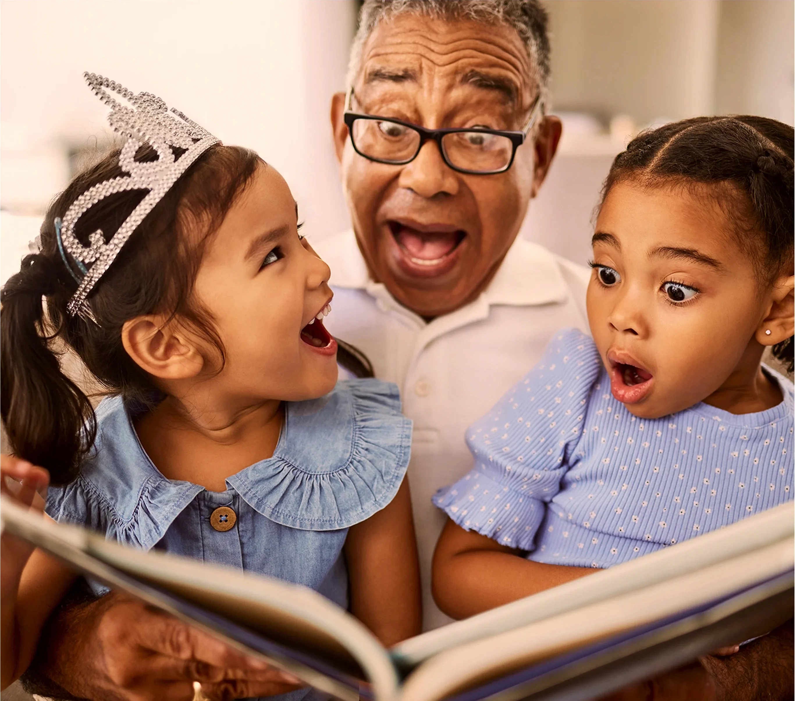Grandfather reading a book to his children