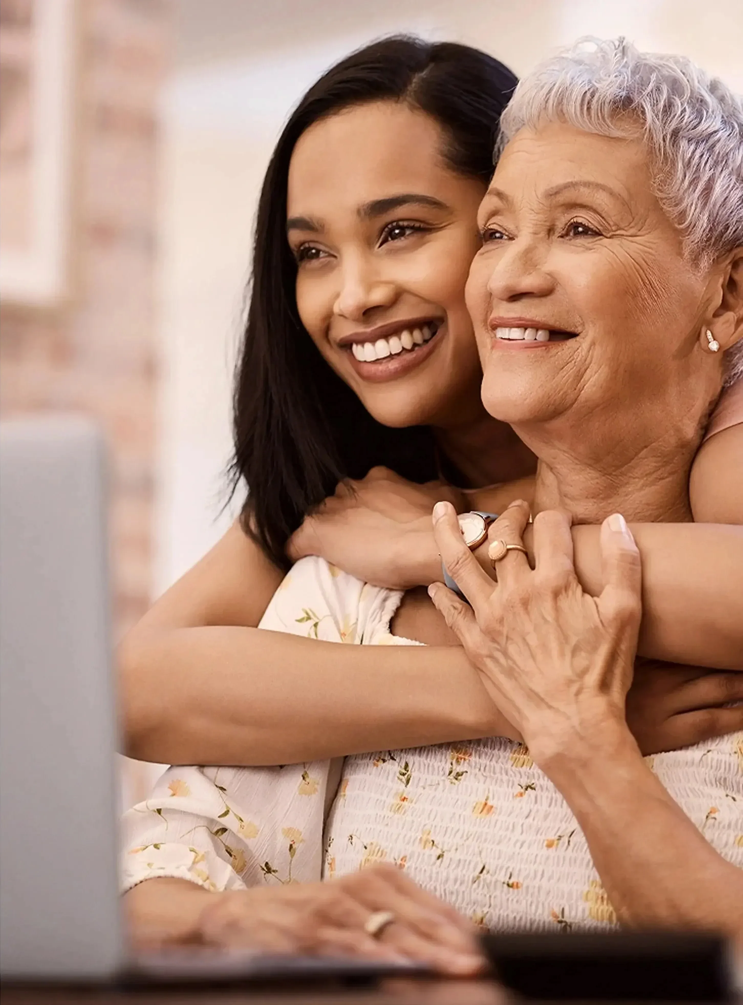 A mom and daughter hugging and smiling